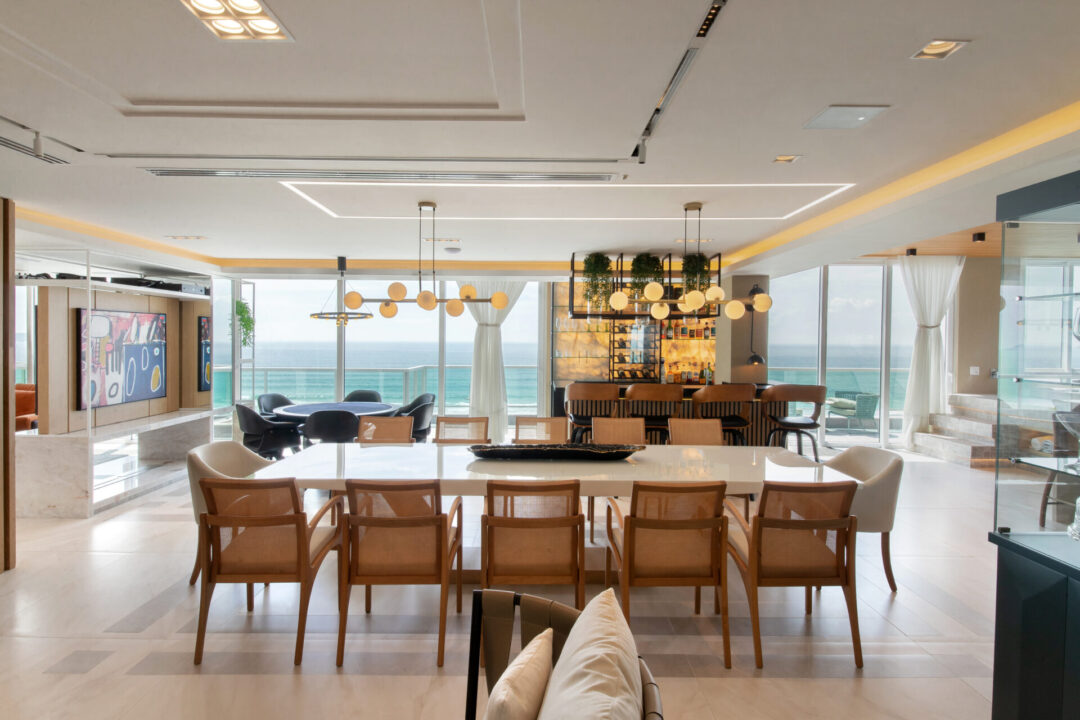 Projeto residencial de uma cobertura no Costão do Santinho em Florianópolis, Santa Catarina. Na foto, a sala principal com vista para o mar, com a mesa de jantar de 12 lugares